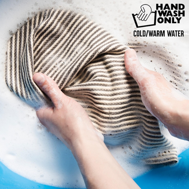 Reusable cotton tote care reference showing unrelated striped fabric being hand washed in cold or warm water.