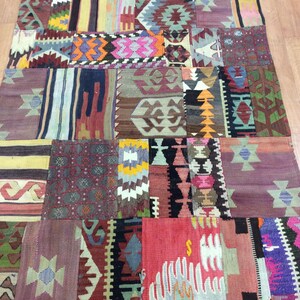 May include: A colorful patchwork rug with a variety of geometric patterns in shades of red, blue, green, yellow, and brown. The rug is made of wool and has a hand-woven texture.