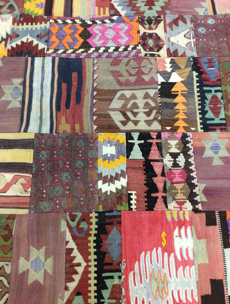 May include: A colorful patchwork rug with a variety of geometric patterns in shades of red, blue, green, yellow, and brown. The rug is made of woven fabric and has a traditional design.