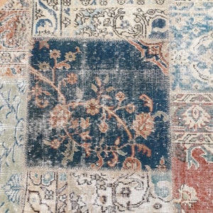 May include: A round patchwork rug with a variety of colors and patterns, including blue, beige, and red. The rug is made of different pieces of fabric sewn together.