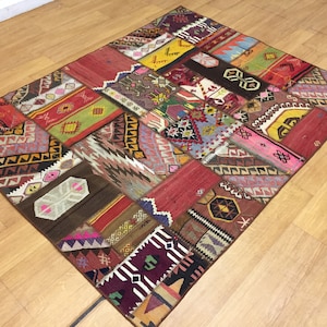 May include: A colorful patchwork rug with a variety of geometric patterns in shades of red, brown, pink, blue, and yellow.