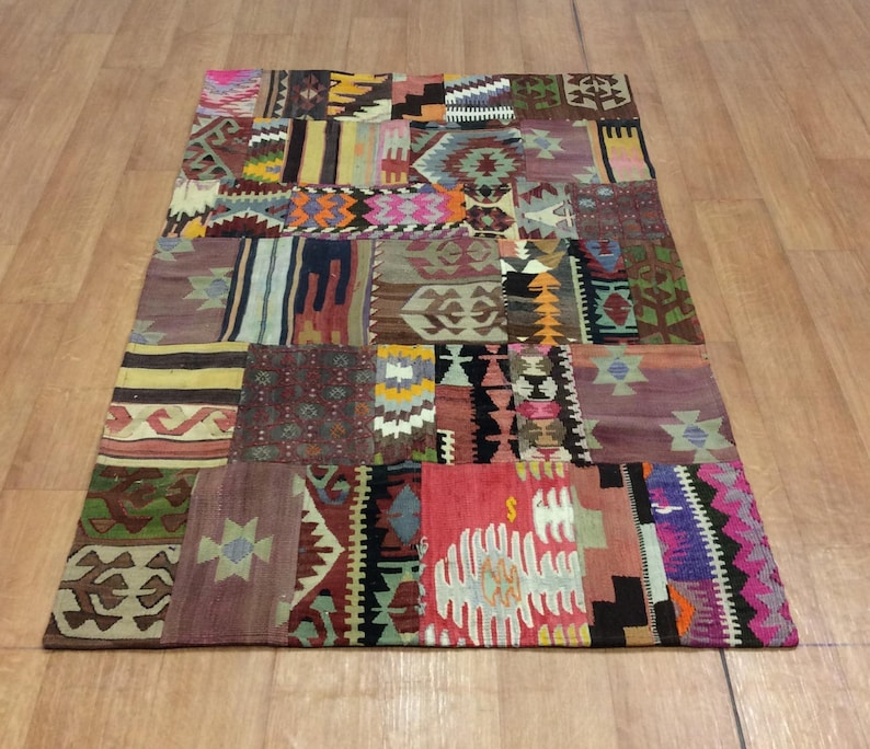 May include: A colorful patchwork rug with a variety of geometric patterns and designs. The rug is made from recycled materials and has a rustic, vintage look.