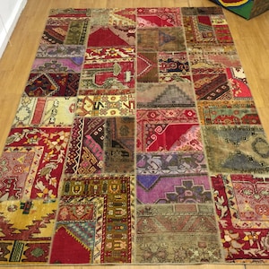 May include: A colorful patchwork rug with a variety of patterns and colors, including red, blue, green, and yellow. The rug is made of different pieces of fabric sewn together.