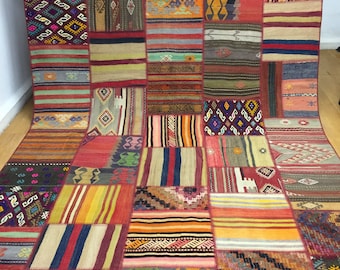 May include: A colorful patchwork rug with a variety of geometric patterns and stripes in shades of red, blue, green, yellow, and brown.