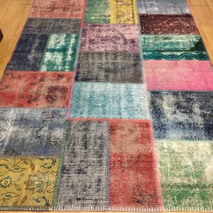 May include: A colorful patchwork rug with a variety of colors and patterns, including red, blue, green, yellow, and pink. The rug is made of recycled materials and has a distressed look.