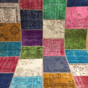 May include: A colorful patchwork rug with a variety of patterns and colors, including blue, green, red, yellow, and purple.