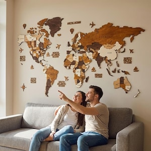 3D wooden world map above sofa — couple pointing at travel destinations on large brown wood wall art, perfect anniversary gift for couples
