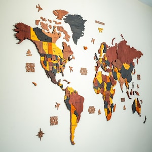 Colorful 3D wooden world map wall decor with multicolor wood layers in yellow, orange, red, grey and brown — handcrafted birch plywood