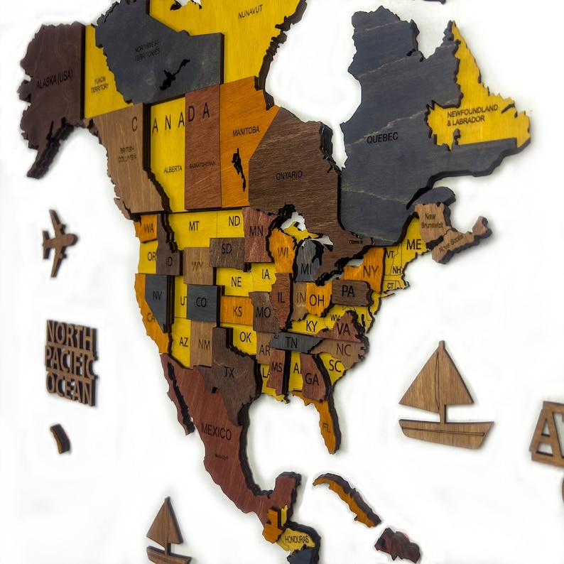 A wooden map of North America with each state and province outlined in a different color. The map is made of different shades of brown and yellow wood. The map is mounted on a white background.