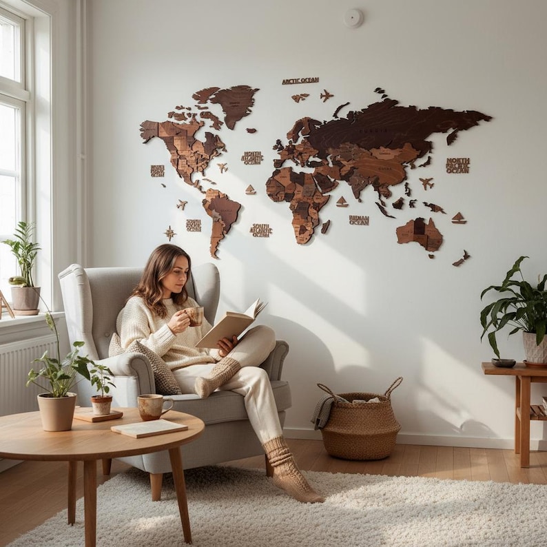 3D wooden world map wall art in dark brown tones, displayed in a cozy Scandinavian living room above a reading chair