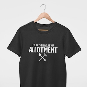 May include: Black t-shirt with white text that reads "I'd rather be at my allotment" with a white shovel and rake graphic.