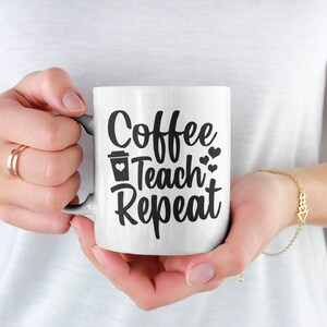 May include: White ceramic coffee mug with black text that reads "Coffee Teach Repeat" and a small coffee cup icon with a heart inside.