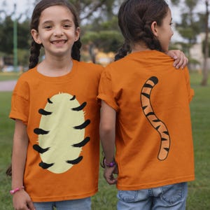 May include: A white ceramic mug with a black handle and the text "But First, Coffee" in a bold, black font. The mug is on a wooden surface. The mug is approximately 10 cm tall.