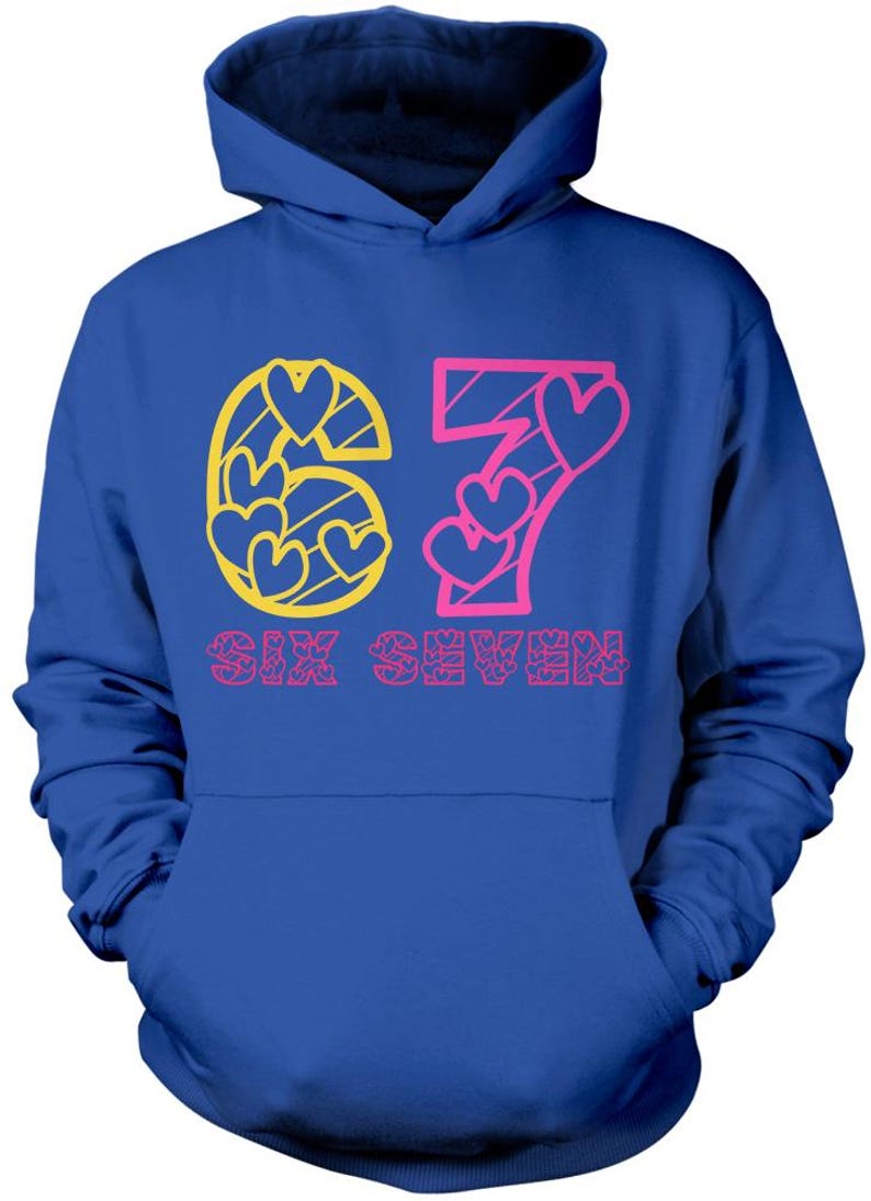 May include: A blue hoodie with a front pocket and a hood. The front of the hoodie features the number "67" in a pink and yellow heart design, with the words "SIX SEVEN" printed below.