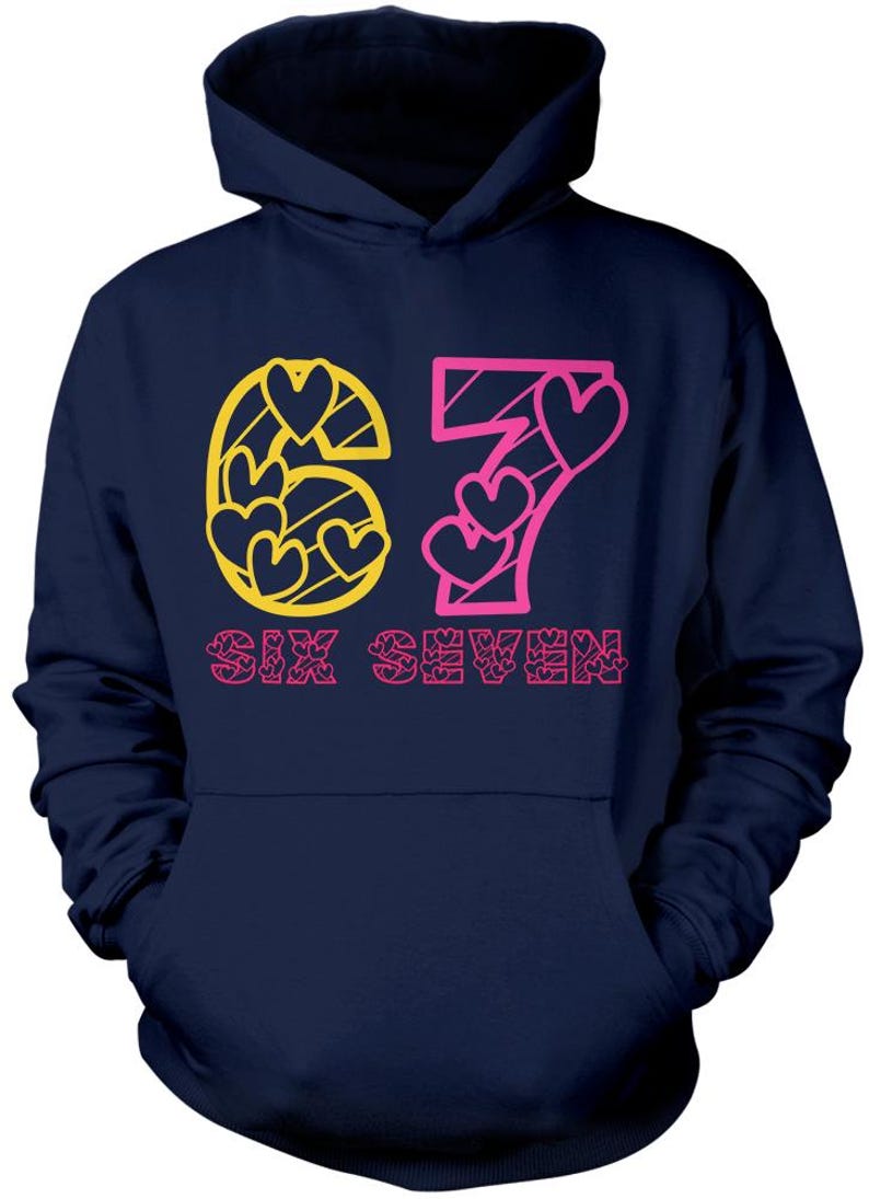 May include: Navy blue hoodie with a front graphic. The graphic features the numbers "67" in yellow and pink, with heart shapes incorporated into the design. The words "SIX SEVEN" are printed below the numbers in pink.