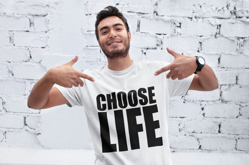 May include: A white t-shirt with the text "CHOOSE LIFE" printed in black bold letters.