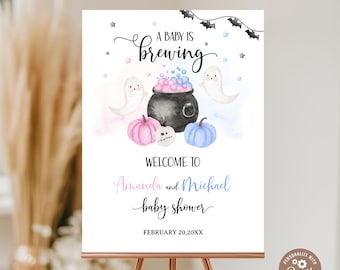 May include: A baby shower sign with a Halloween theme. The sign features a cauldron with pink and blue bubbles, ghosts, pumpkins, and the text "A Baby is Brewing." It welcomes guests to Amanda and Michael's baby shower.