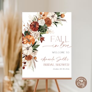May include: A rectangular sign featuring a floral arrangement of pumpkins, dried grasses, and autumn leaves in shades of orange, white, and green. The text reads: FALL in love, WELCOME TO, Amanda Smith's BRIDAL SHOWER, October 05. 05. 202x.
