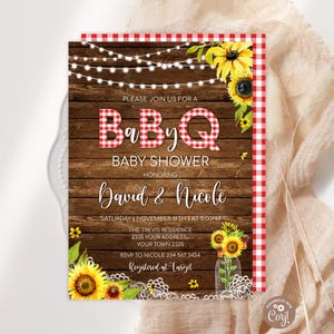 May include: Baby shower invitation with a BBQ theme. The design features a wooden background, red gingham accents, sunflowers, and string lights. The invitation text includes the names "David & Nicole" and event details.