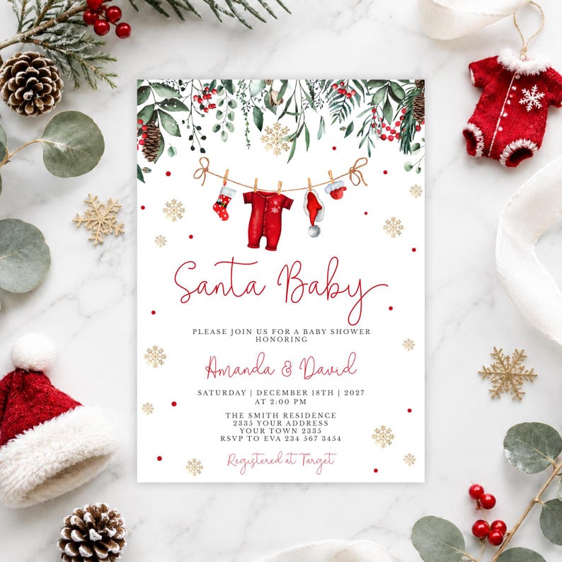 May include: A rectangular baby shower invitation card featuring a watercolor illustration of a clothesline with a red onesie, a stocking, and a hat. The text reads Santa Baby, Amanda & David, Saturday December 18th 2027 at 2:00 PM, The Smith Residence, 2335 Your Address, Your Town 2335, RSVP to Eva 234 567 3454, Registered at Target.