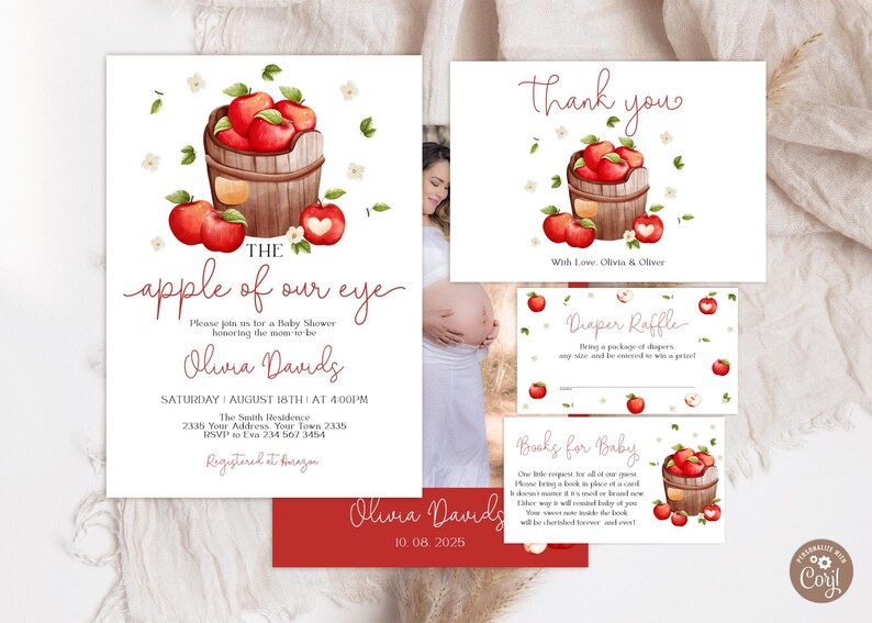 Może przedstawiać: Zestaw zaproszeń na baby shower z akwarelowymi czerwonymi jabłkami w drewnianym koszyku, z napisem The apple of our eye, Olivia Davids oraz szczeg&oacute;łami wydarzenia. Zawiera kartkę z podziękowaniami i karty do loterii pieluszkowej.