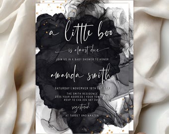 Op de afbeelding: Een rechthoekige uitnodigingskaart voor een babyshower met een zwart-wit inktontwerp en gouden spikkels. De tekst luidt: a little boo is almost due, join us in a baby shower to honor amanda smith, saturday november 18th at 3pm.