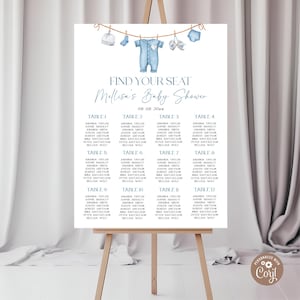 May include: A baby shower seating chart displayed on an easel. The design features a light blue color scheme with illustrations of baby clothes and the text "Find Your Seat Mellisa's Baby Shower". The names are listed in columns.