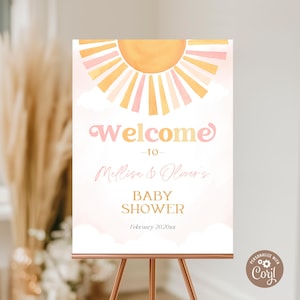 May include: A baby shower welcome sign featuring a watercolour sun design in yellow, peach, and pink. The sign reads "Welcome to Melissa & Oliver's BABY SHOWER" with the date February 20, 20xx.