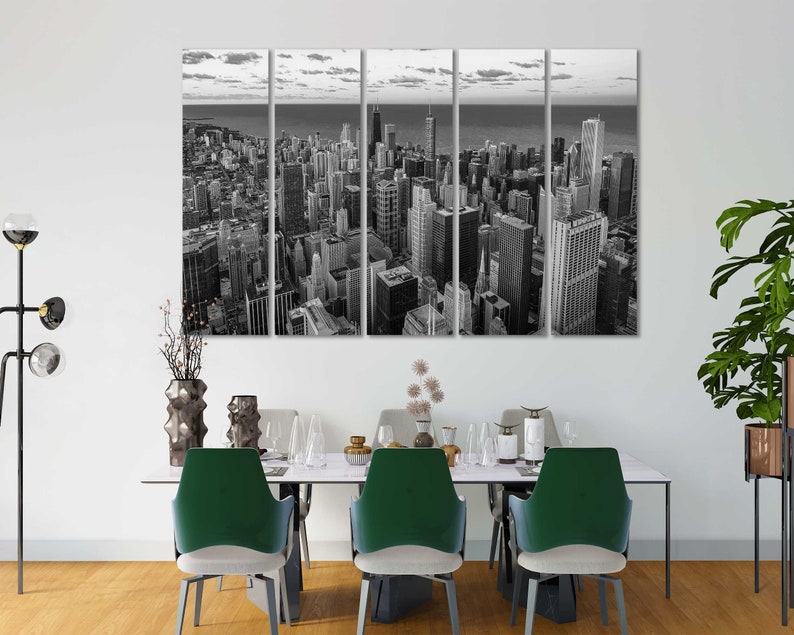 May include: Black and white panoramic photograph of a city skyline. The image is split into six panels, showing a cityscape with tall buildings and a river in the distance.