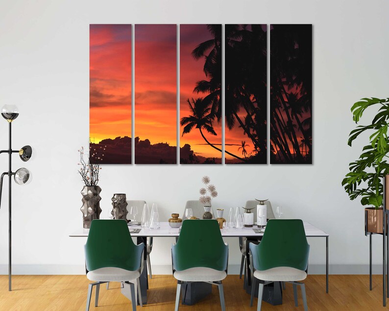 May include: A multi-panel canvas print featuring a sunset over a tropical island with palm trees silhouetted against the orange and red sky.