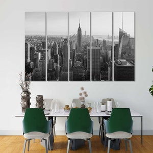 May include: Black and white photo of the New York City skyline, featuring the Empire State Building and Chrysler Building. The photo is split into five panels, creating a modern and abstract look.