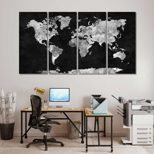 May include: A black and white world map canvas print, divided into four panels, hangs above a desk with a computer, chair, and printer. The map is a stylised, abstract design with a distressed, textured look.