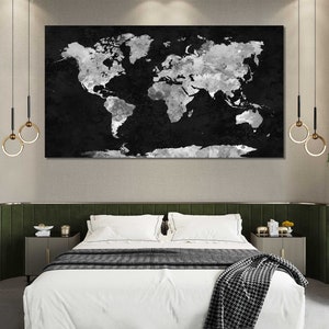 May include: A black and white world map print with a distressed, watercolour effect hangs above a white bed with a green headboard. The bed has a white duvet and a black and white throw blanket.