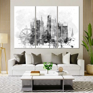 May include: A black and white watercolor painting of a city skyline with a Ferris wheel in the foreground. The painting is divided into three panels.