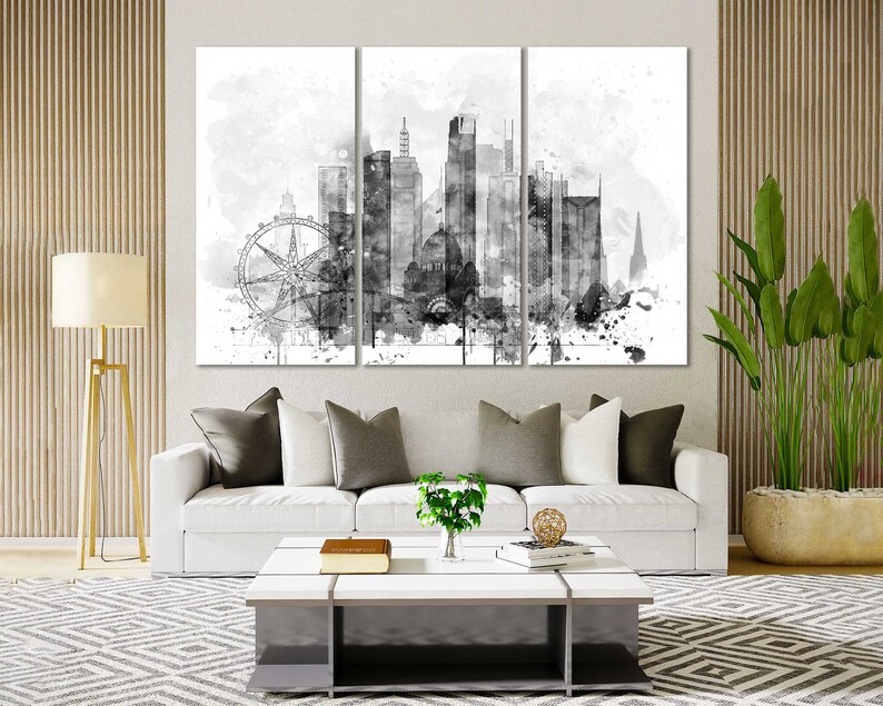 May include: A black and white watercolor painting of a city skyline with a Ferris wheel in the foreground. The painting is divided into three panels.