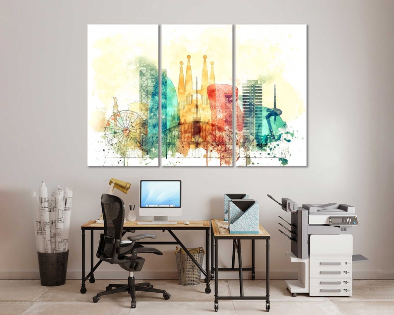 May include: A watercolor painting of a cityscape with a Ferris wheel, buildings, and a red balloon. The painting is divided into three panels and is framed in a modern office setting with a desk, chair, and printer.