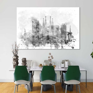 May include: A black and white watercolor painting of the Barcelona skyline. The painting features iconic landmarks like the Sagrada Familia and the Ferris wheel. The painting is set against a white background.