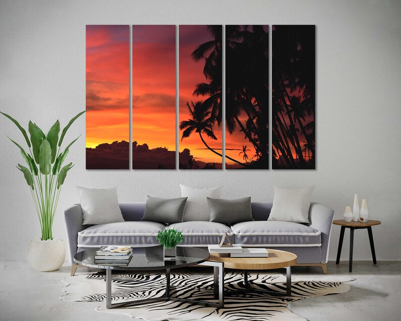 May include: A multi-panel canvas print featuring a sunset over a tropical island with palm trees silhouetted against the orange and red sky.