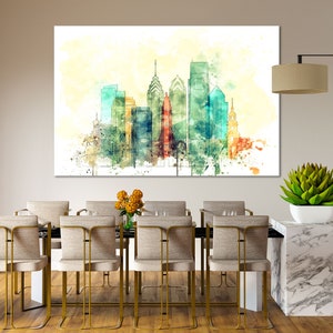 May include: A watercolor painting of the Philadelphia skyline with a light yellow background. The painting is hanging on a wall above a dining table with six chairs.