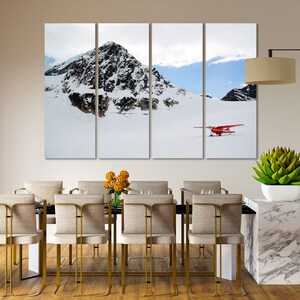 May include: A red airplane sits on a snowy mountain landscape with a mountain peak in the background. The scene is split into three panels.