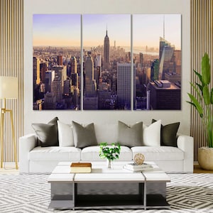 May include: A panoramic view of the New York City skyline at sunset, featuring tall skyscrapers and buildings. The image is split into three sections, showing the city from different angles.