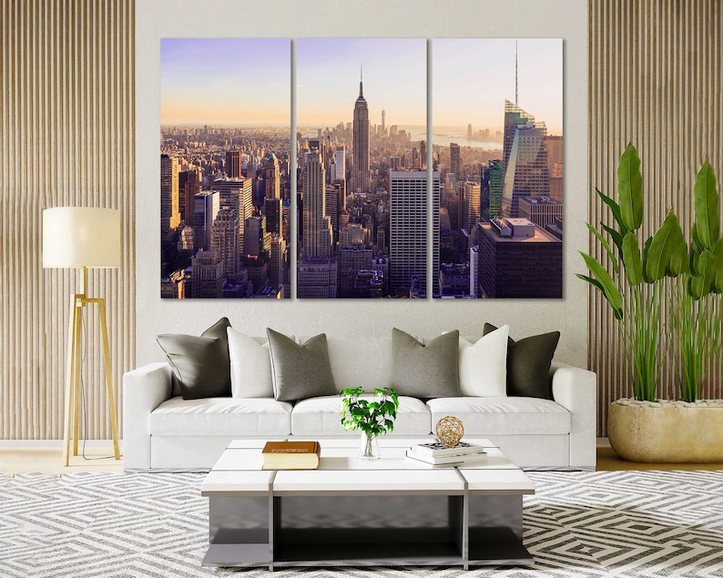 May include: A panoramic view of the New York City skyline at sunset, featuring tall skyscrapers and buildings. The image is split into three sections, showing the city from different angles.