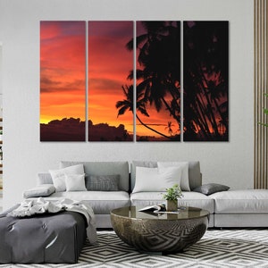 May include: A multi-panel canvas print featuring a sunset over a tropical island with palm trees silhouetted against the orange and red sky.