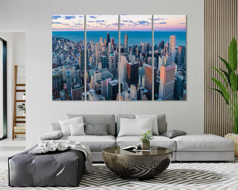 May include: A panoramic view of a city skyline with tall buildings and a blue sky with clouds. The city is seen from above, with the buildings arranged in a grid pattern. The sky is a light blue with white clouds.