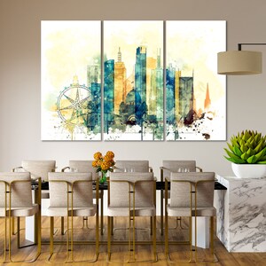 May include: A watercolor painting of a city skyline with a Ferris wheel in the foreground. The painting is divided into three panels and features a mix of blue, yellow, and brown colors.