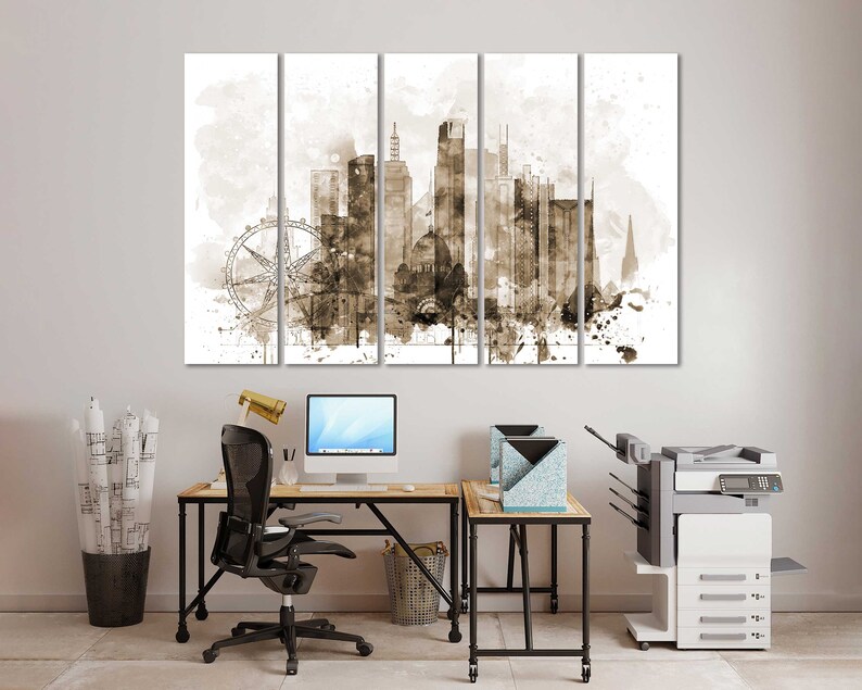 May include: A sepia-toned canvas print of a city skyline with a Ferris wheel in the foreground. The print is divided into five panels, each with a different section of the city. The print is hanging on a white wall above a desk with a computer, chair, and printer.