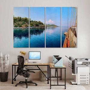 May include: A multi-panel canvas print featuring a scenic view of a boat sailing in a calm blue bay with lush green islands in the background.