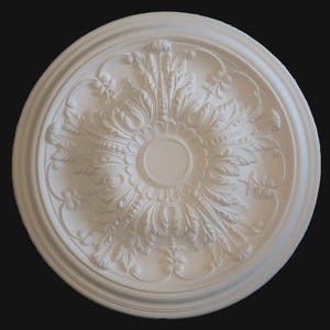 May include: A white, circular ceiling medallion with intricate floral and leaf patterns. The decorative plaster element features a central circular design surrounded by detailed relief work, perfect for interior design projects.