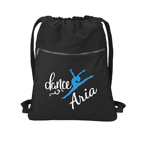 May include: Black drawstring bag with a zippered pocket. The bag features a blue silhouette of a dancer with the text "dance" and "Aria" in white.