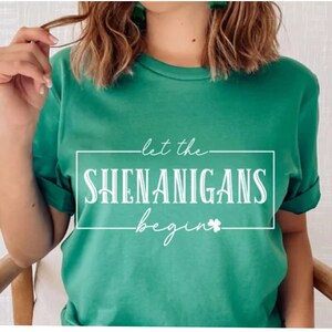 May include: Green t-shirt with white text that reads "let the shenanigans begin" with a shamrock.